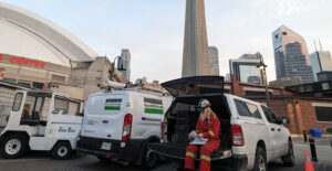 onsite rescue with a worker outdoor near the CN Tower in Toronto with other work trucks