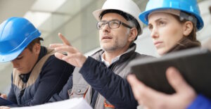 people wearing hard hats consulting and planning