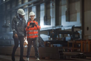 Image of two construction workers consulting